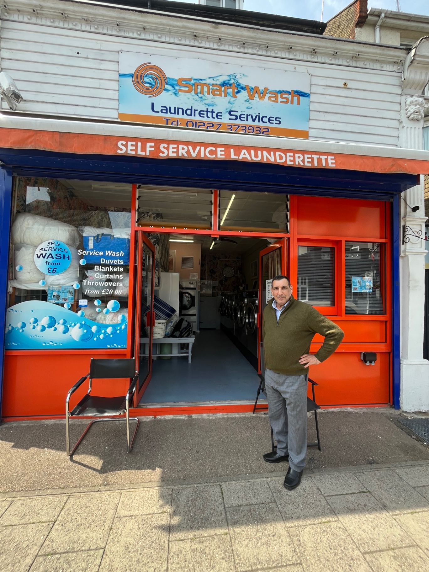 Smart Wash storefront on Station Road, Herne Bay — bright orange shopfront with blue trim